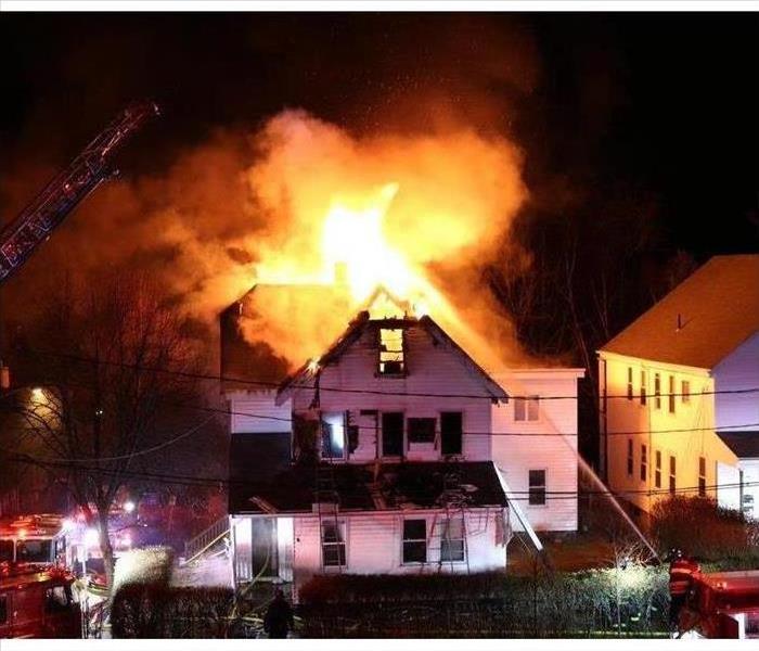 Home with roof engulfed in flames